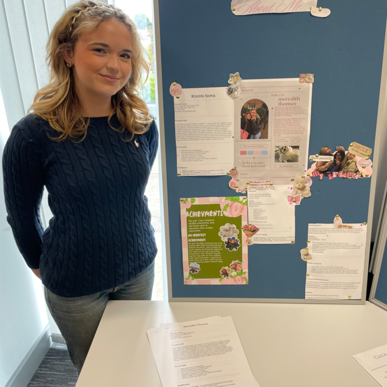 Student stood with her display of work