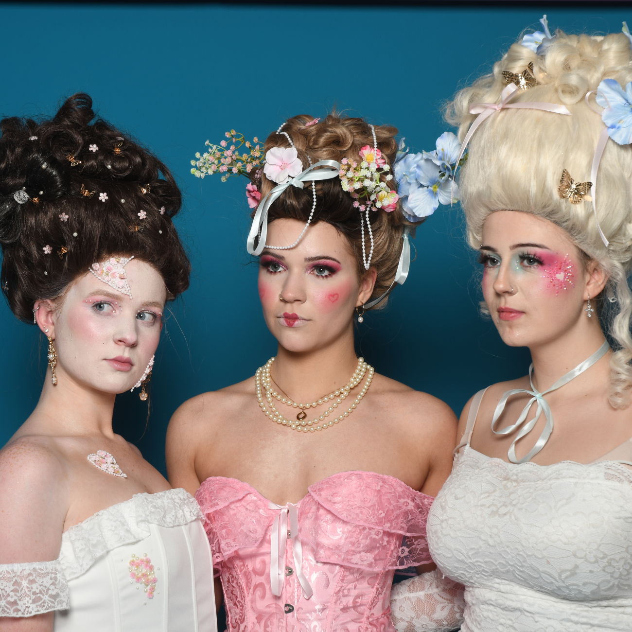 Three hair and Makeup models posing together in photoshoot