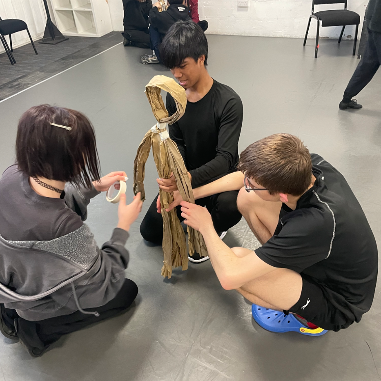 students making puppets out of paper