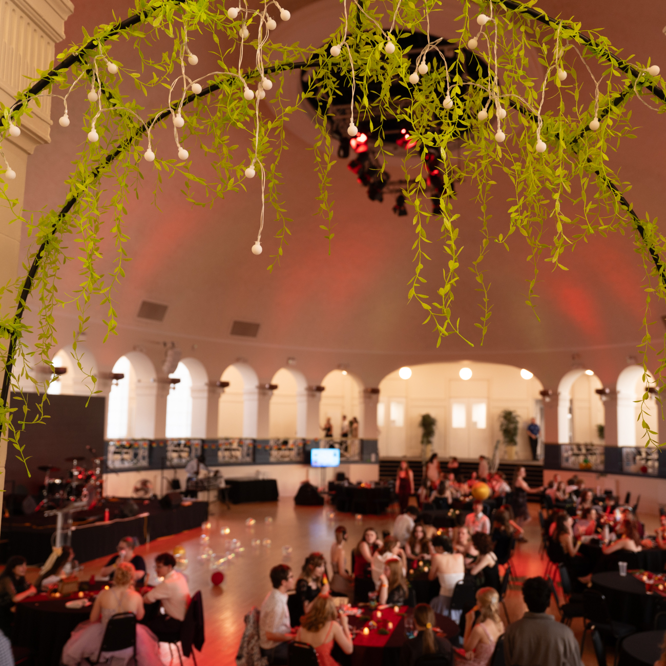 Winter Gardens entrance with greenery and students celebration in the background