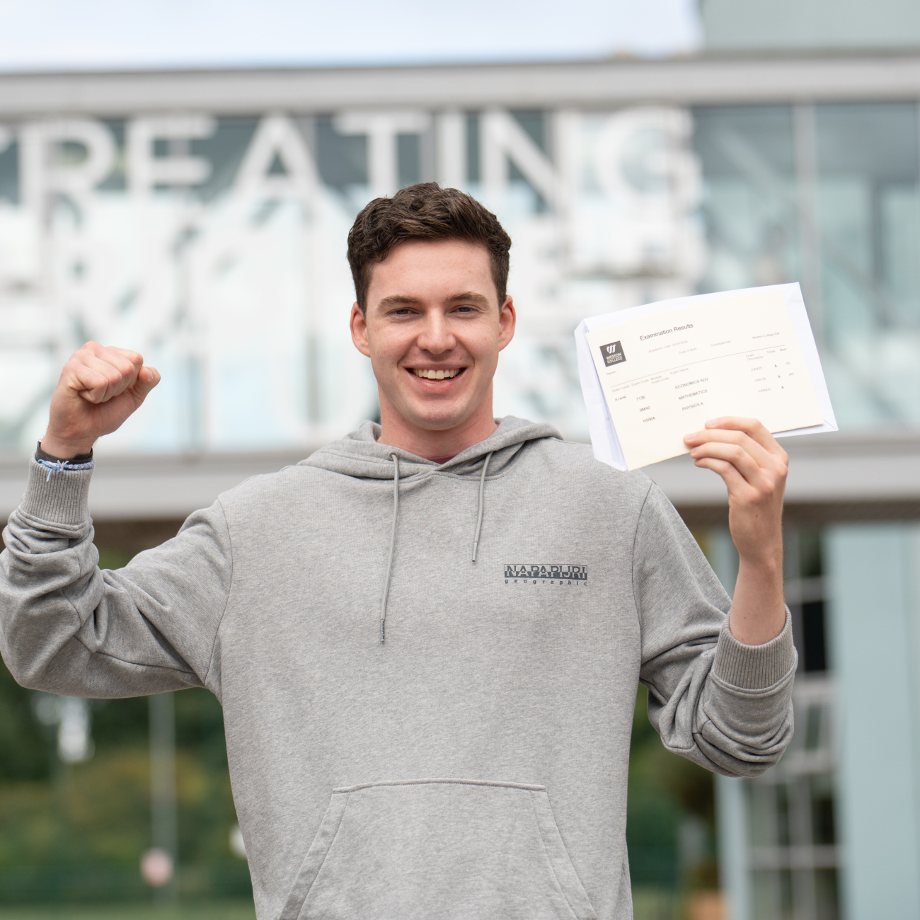 Student celebrating whilst collecting results