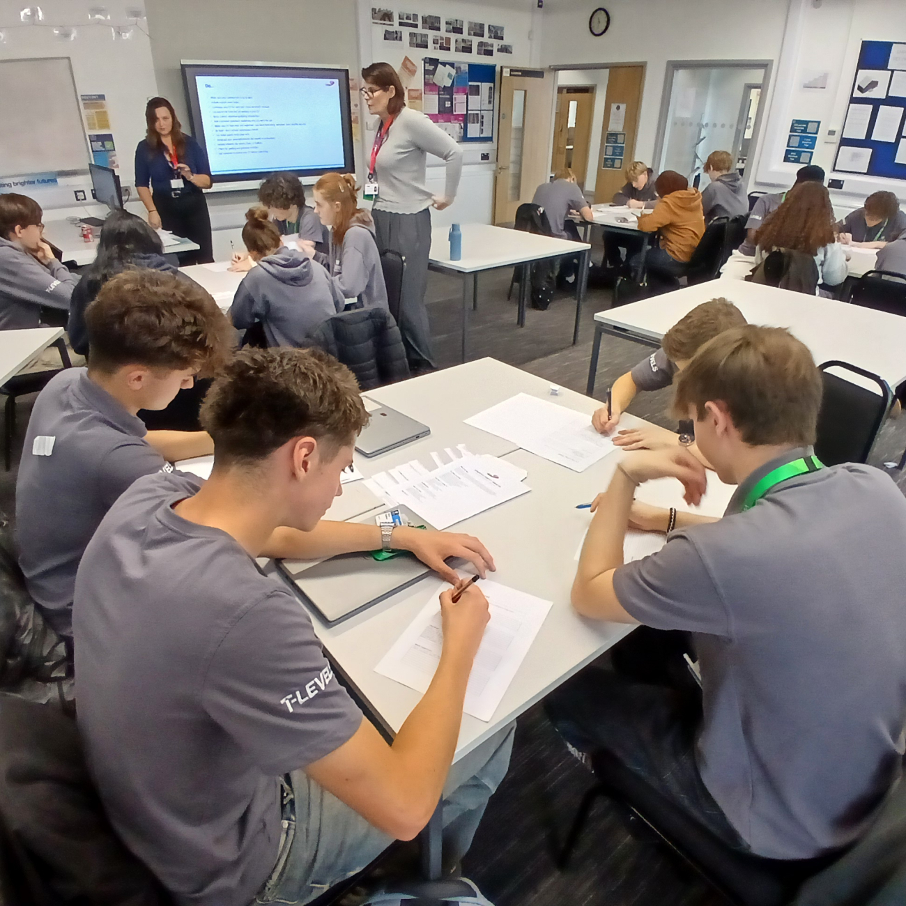 Students sat at tables while writing during CV workshop