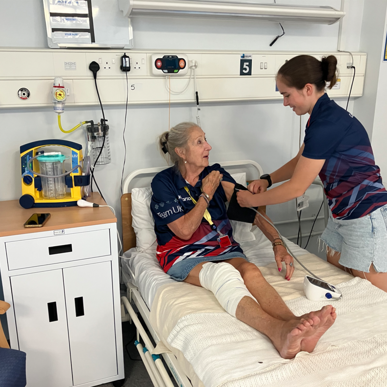 Competitor checking the blood pressure of Team UK staff member