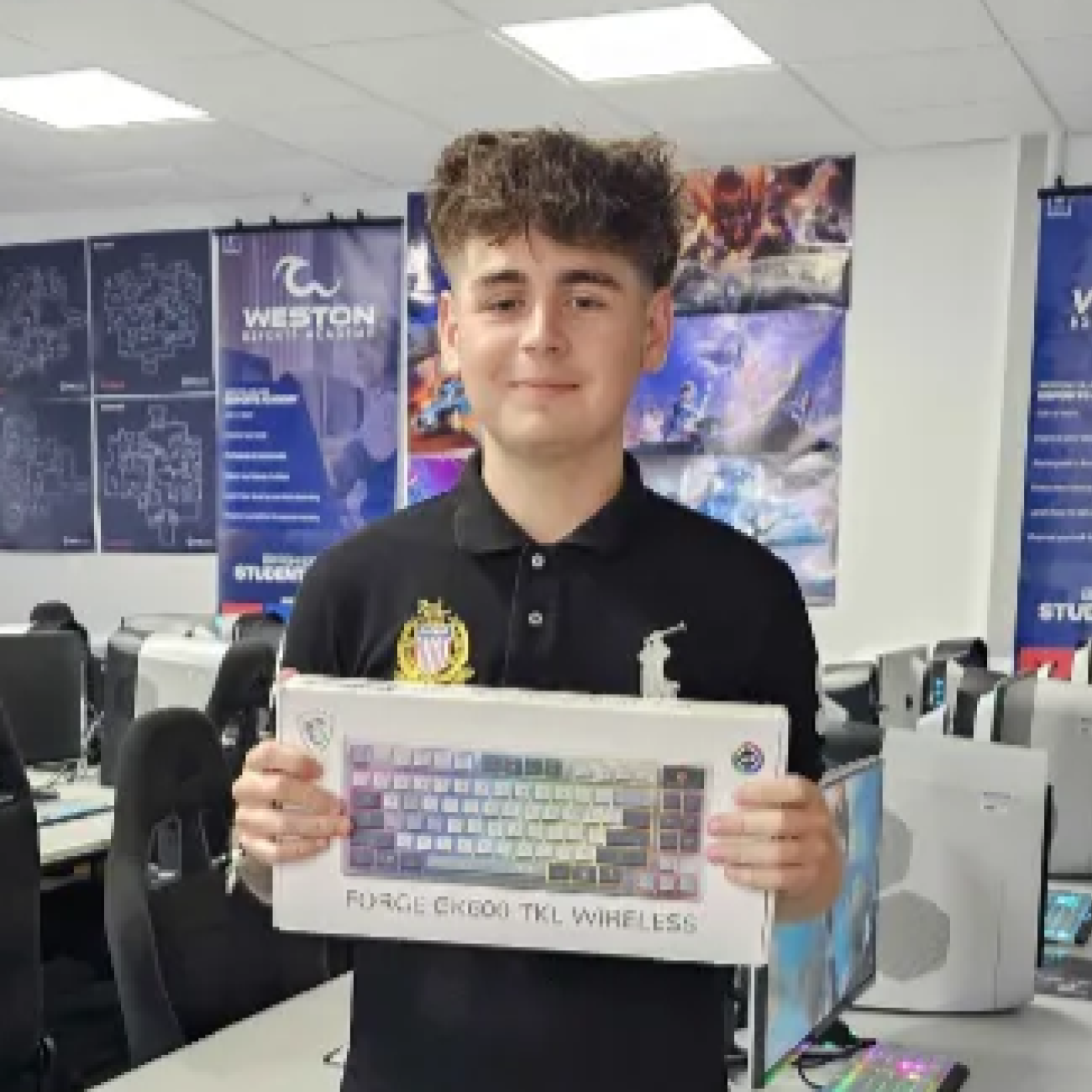 Student smiling and holding the MSI Keyboard he won