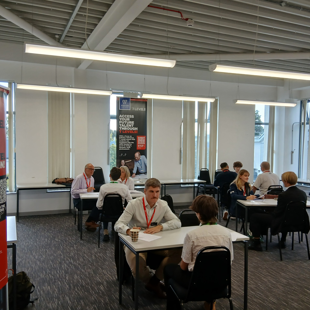 Speed interviews happening around the classroom on small tables