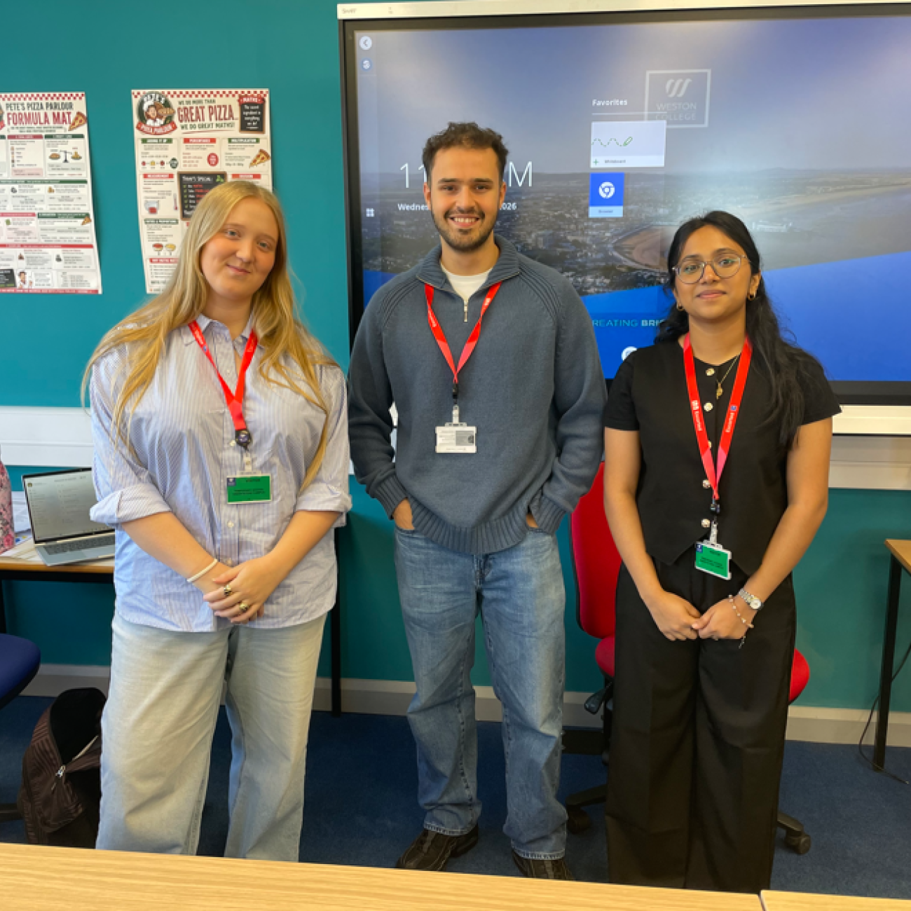 EY Employees smiling at the front of the classroom