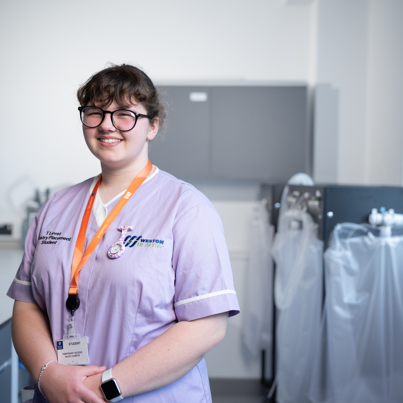 health student smiling in her scrubs