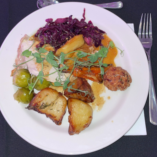 Roast turkey dinner with roast potatoes, vegetables and stuffing