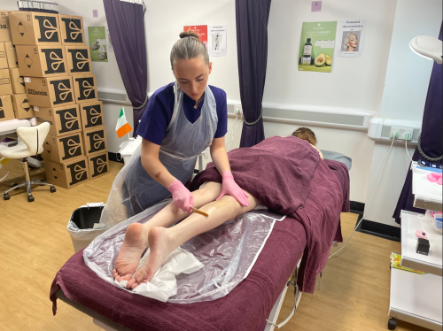 Competitor from Spain waxing clients leg