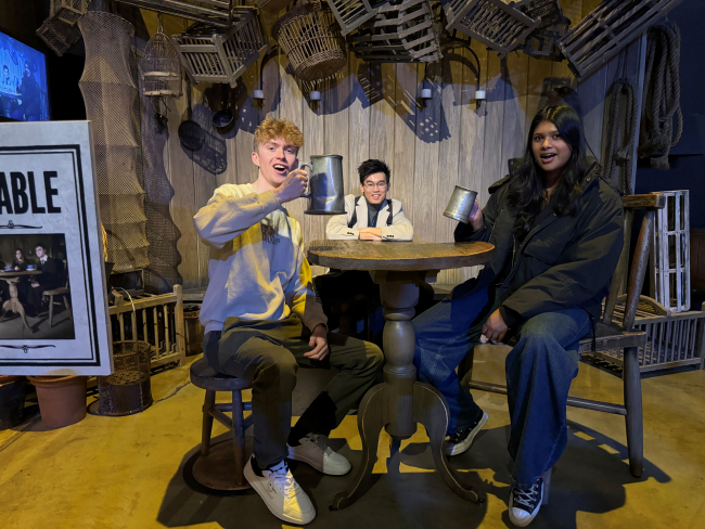 students and media lecturer at table at harry potter studios