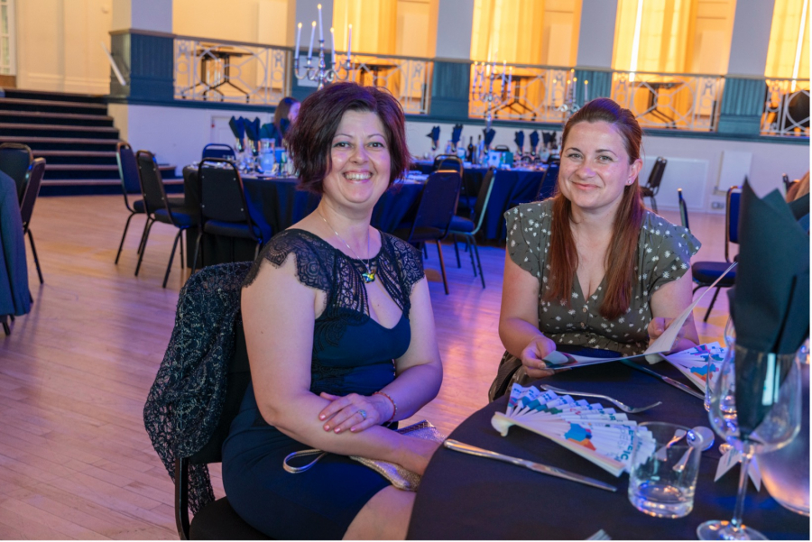 Preslava sitting at a table with another women