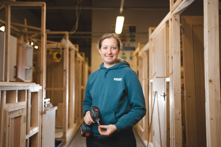 sophie standing with a drill