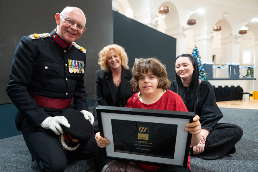 Caitlin with her award with her tutors, the college principal and brigadier