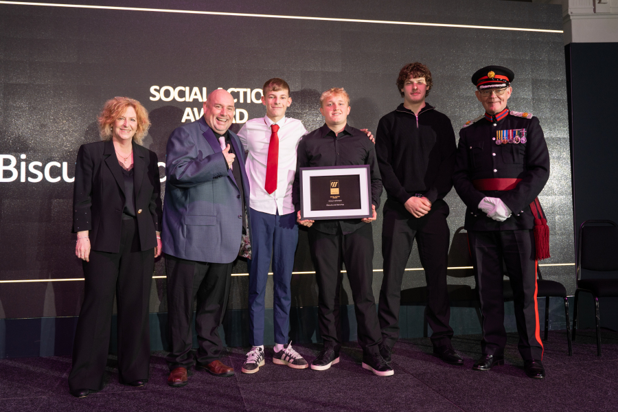 Students from the Biscuit and Benches project collecting award