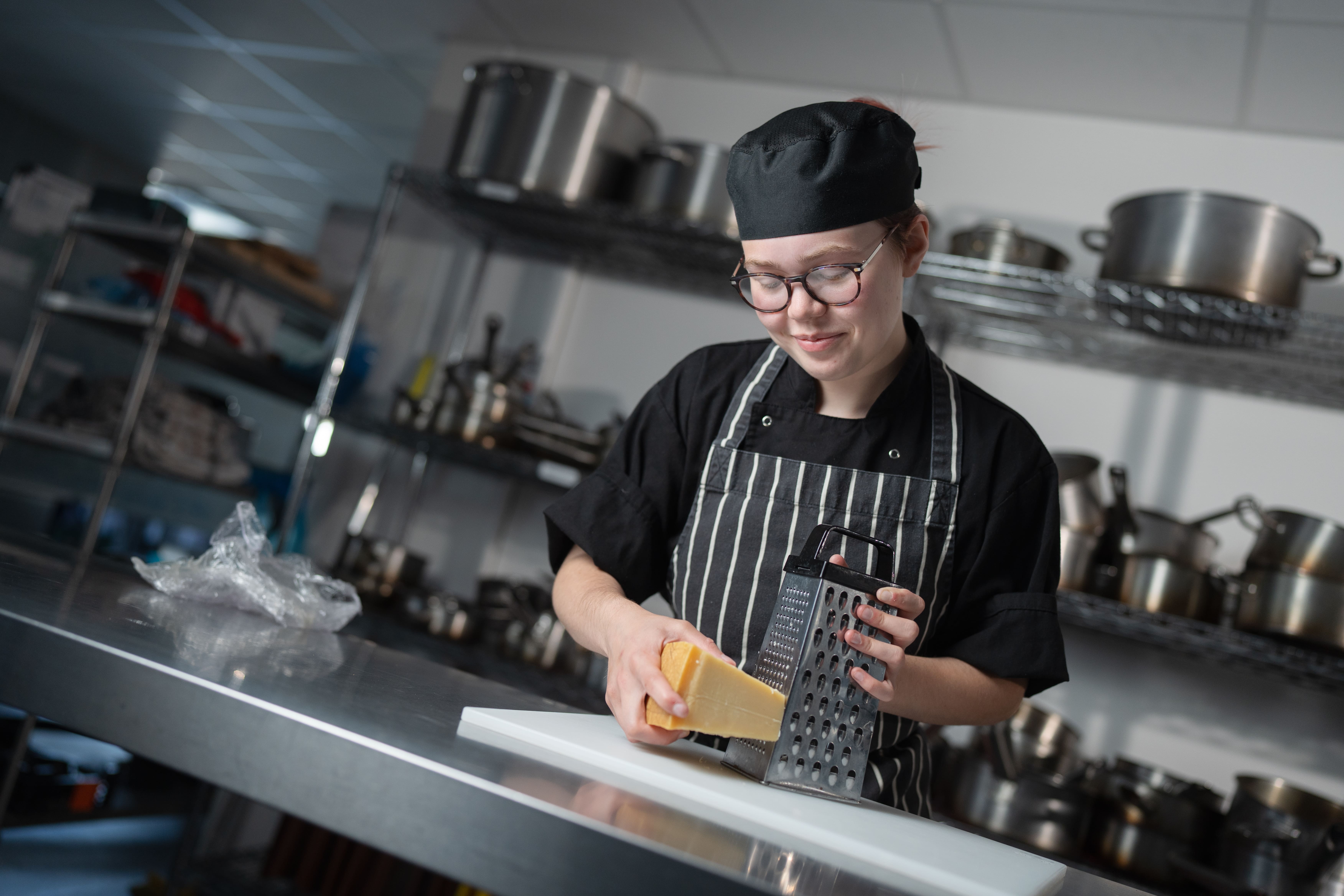 female student grating cheese