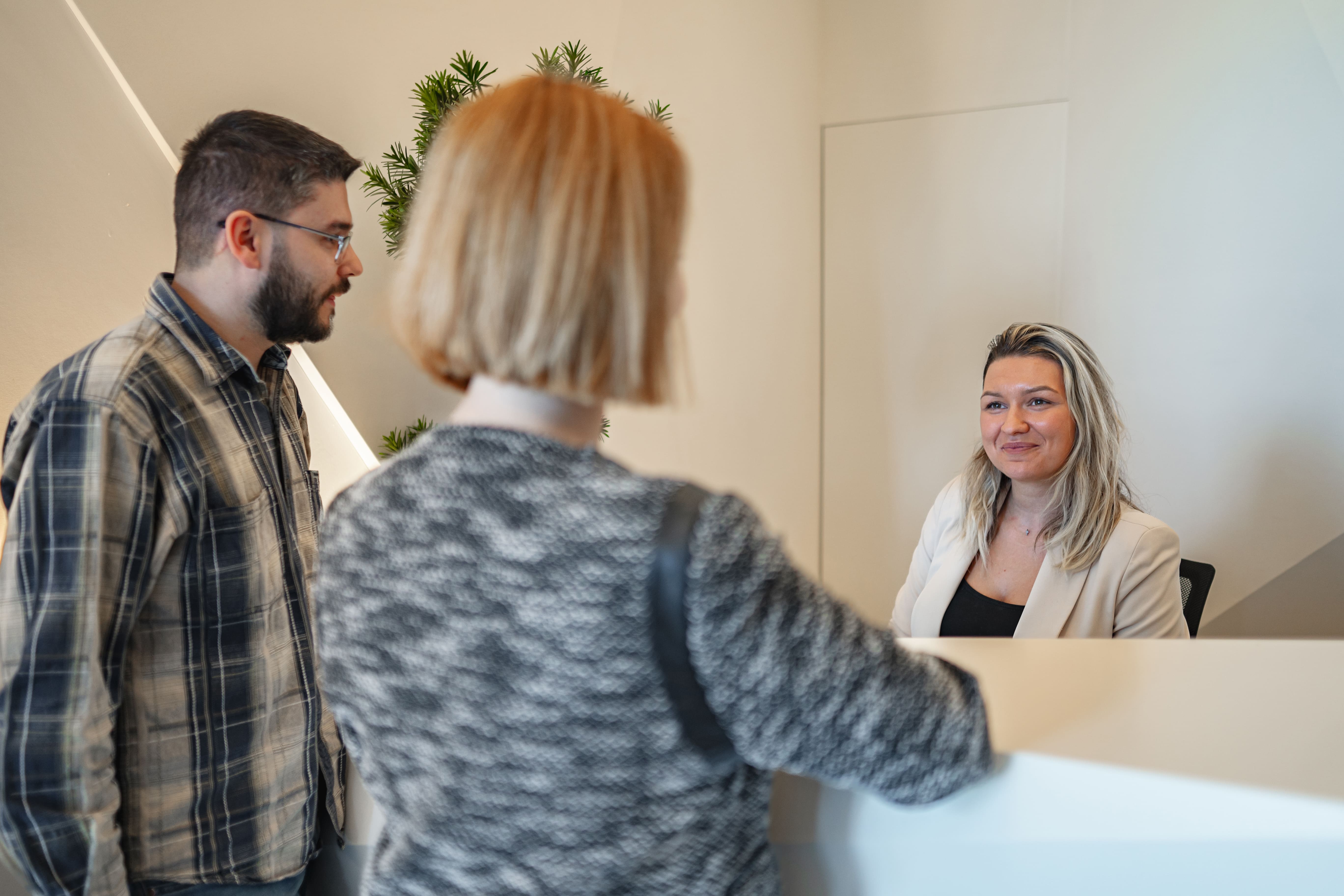 Woman Speaking to Man in Front of Mirror